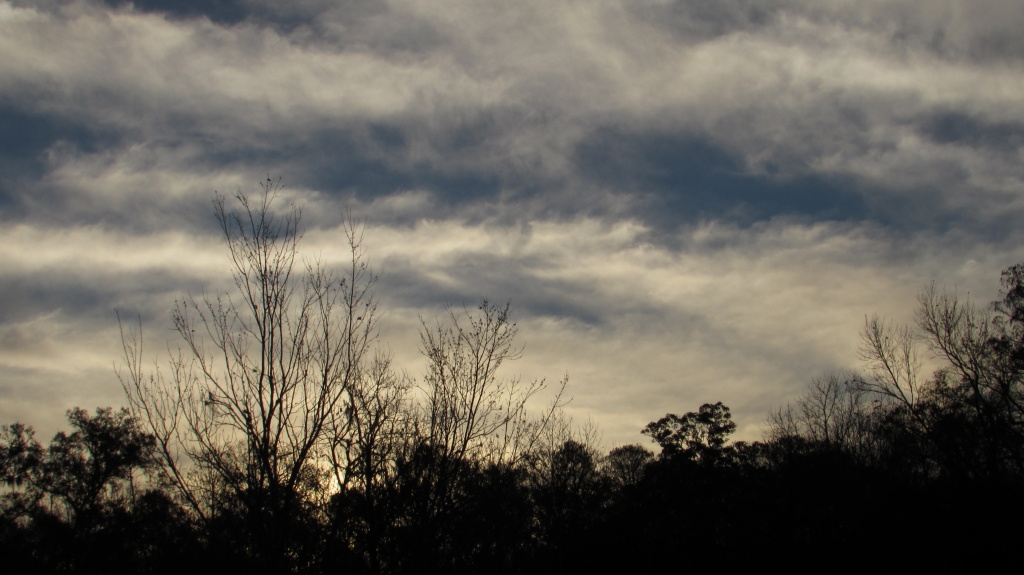 Soft clouds open to reveal the blue morning sky